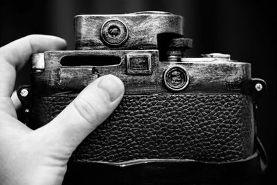 Close-up of hand holding vintage camera