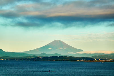 Scenic view of lake against cloudy sky