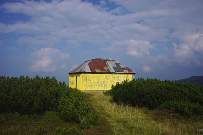 House on field against sky