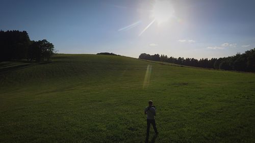 Scenic view of golf course on field against sky