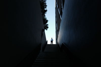 Low angle view of man standing at one maritime plaza in city