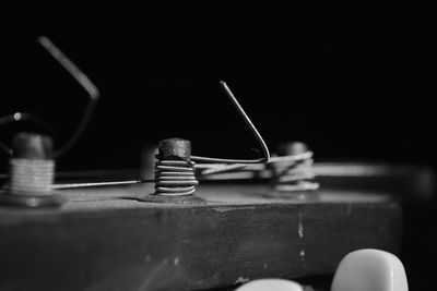 Close-up of electric lamp on table against black background