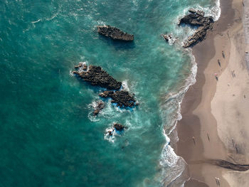 High angle view of rocks in sea