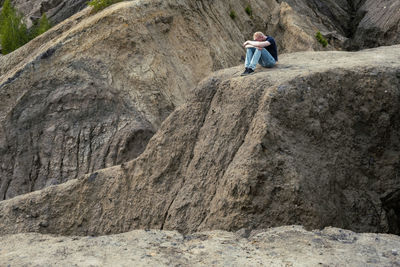 Rear view of man walking on rock