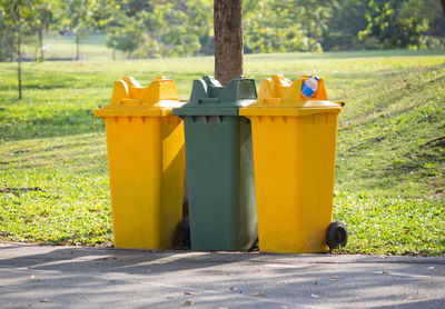 Yellow garbage can in park