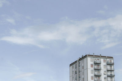 Low angle view of building against cloudy sky