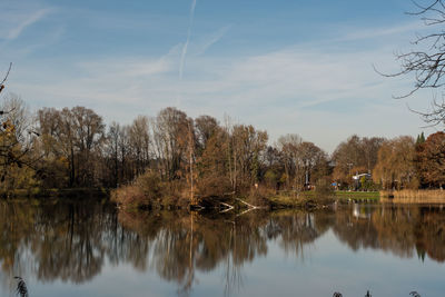 Reflection of trees in lake against sky