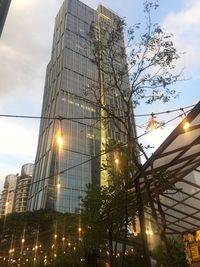 Low angle view of illuminated buildings against sky