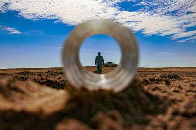 Man standing on field against sky