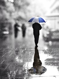 Woman with umbrella in background