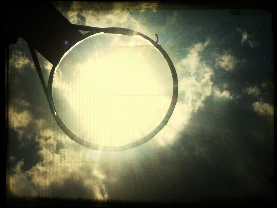 sky, circle, low angle view, cloud - sky, sphere, indoors, reflection, geometric shape, transfer print, no people, auto post production filter, glass - material, built structure, lighting equipment, cloud, close-up, sunlight, day, transparent, round