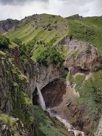 Scenic view of waterfall against sky