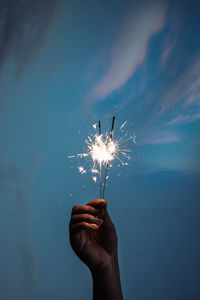 Person hand holding firework display