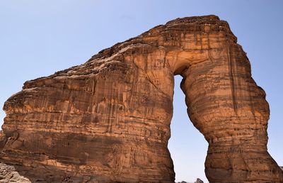 Low angle view of rock formation against clear sky