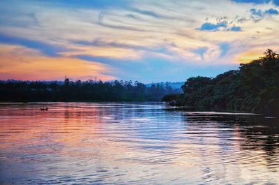 Scenic view of lake against cloudy sky