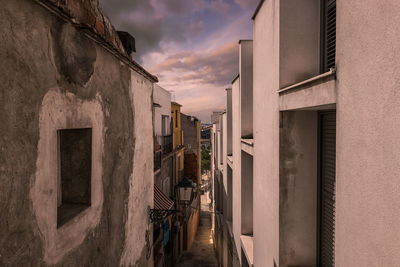 Buildings against cloudy sky during sunset