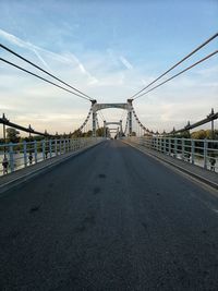 Bridge over road in city against sky