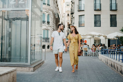 Portrait of young woman standing in city