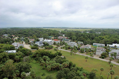 View of cityscape against cloudy sky