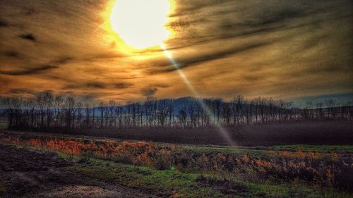 Scenic view of field against sky during sunset