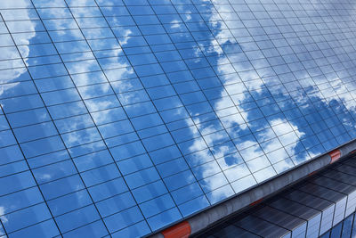 Low angle view of glass building against sky