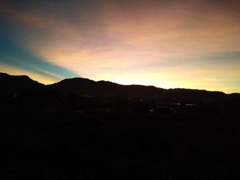 Scenic view of silhouette mountains against sky during sunset