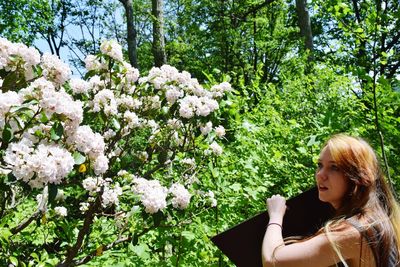 Young woman with flowers on tree