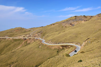 Scenic view of mountain road against sky