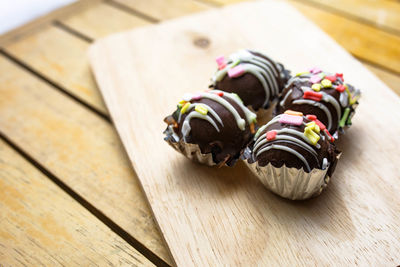 High angle view of chocolate cupcakes on cutting board