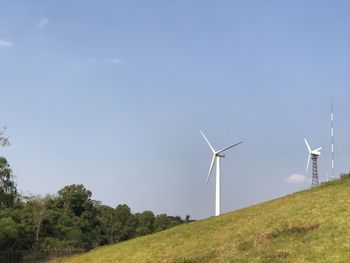 Windmill on field against sky