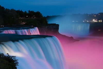 Scenic view of river against clear sky at night