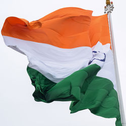 India flag flying high at connaught place with pride in blue sky, india flag fluttering, indian flag