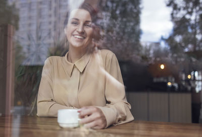 Portrait of young woman drinking glass