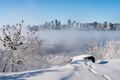 Scenic view of city against clear sky during winter