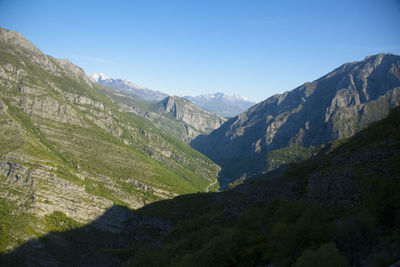 Scenic view of mountains against clear blue sky