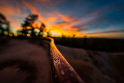 Close-up of water on land against sky during sunset
