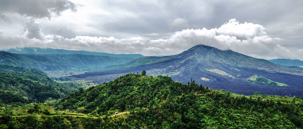 Scenic view of mountains against cloudy sky