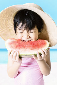 Close-up portrait of girl eating watermelong