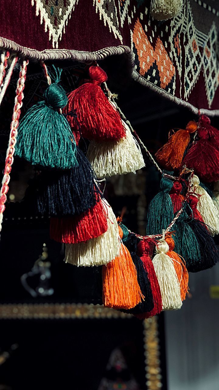 CLOSE-UP OF MULTI COLORED UMBRELLAS HANGING AT MARKET