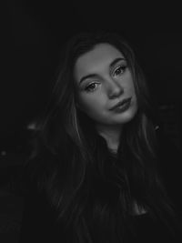 Portrait of smiling woman in darkroom