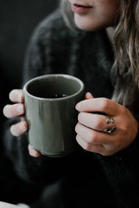 Close-up of woman holding coffee cup