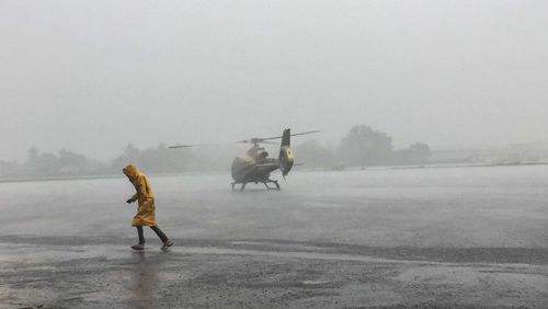 Airport worker running in the rain 