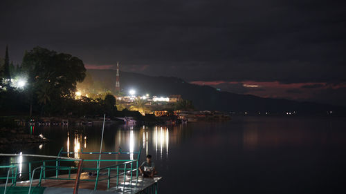 Illuminated buildings against sky at night
