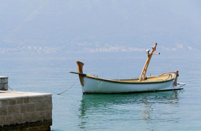 Boat moored in sea against sky