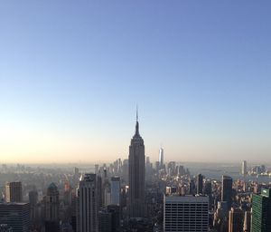 Modern buildings in city against clear sky