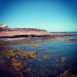 Scenic view of sea against clear blue sky