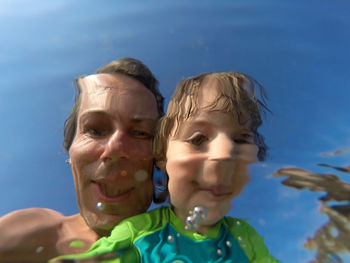 Reflection of father and daughter seen in water