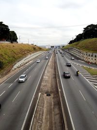 Vehicles on road against sky