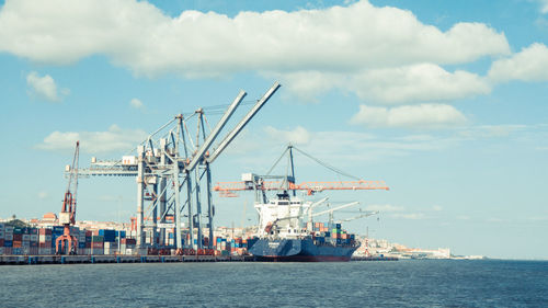 Harbor against cloudy sky