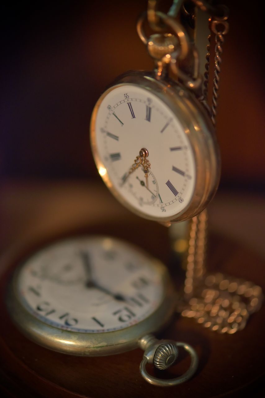 CLOSE-UP OF CLOCK ON TABLE AT HOME